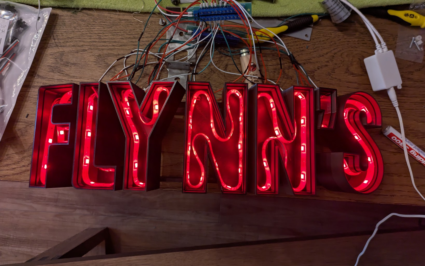 Gluing the cut-up LED strips into the letters